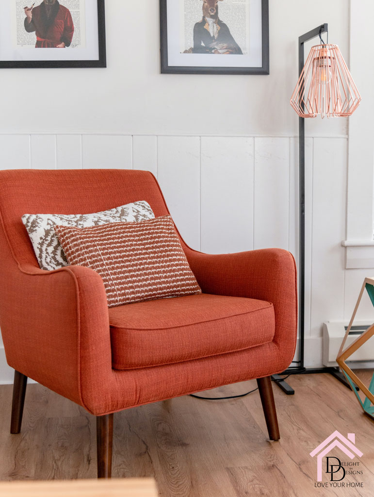 a chair with a pillow on it in a room.