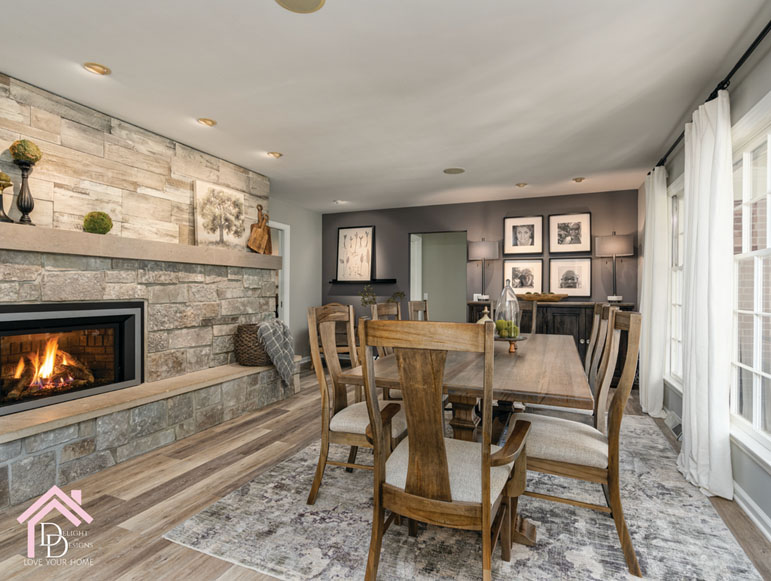 a dining room table with chairs and a fire place.