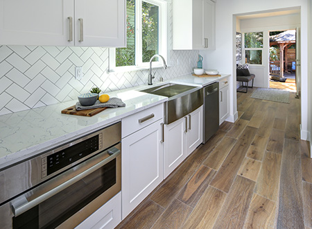 Long kitchen with wood patterned floor