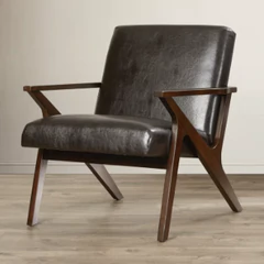 a brown leather chair sitting on top of a hard wood floor.