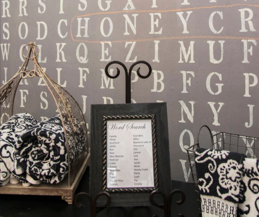 a black and white wall with letters on it.
