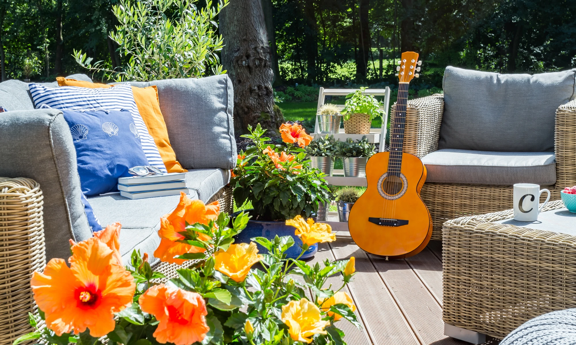 a guitar sitting on top of a wooden deck.