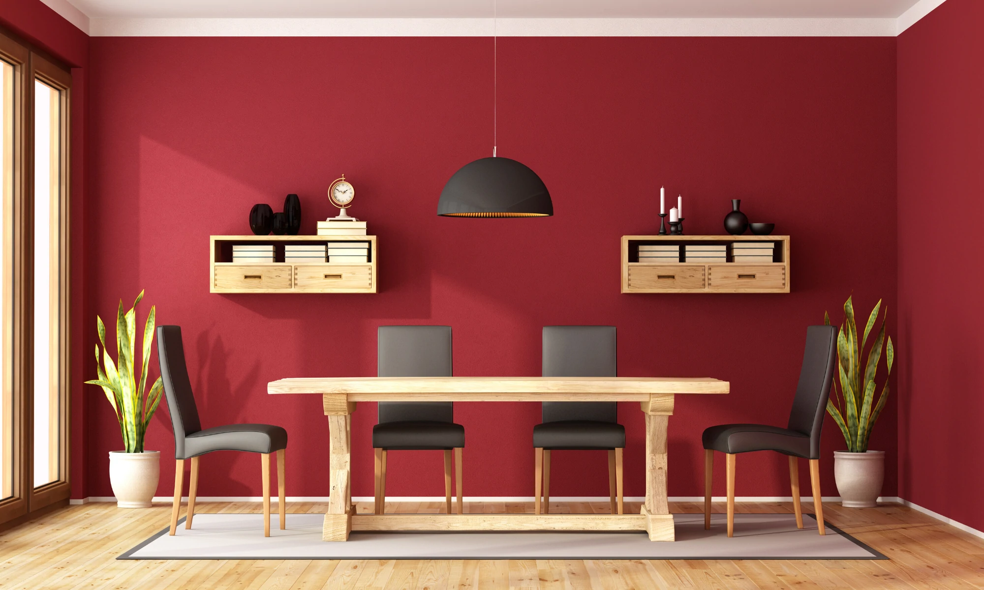 a dining room with red walls and a wooden table.