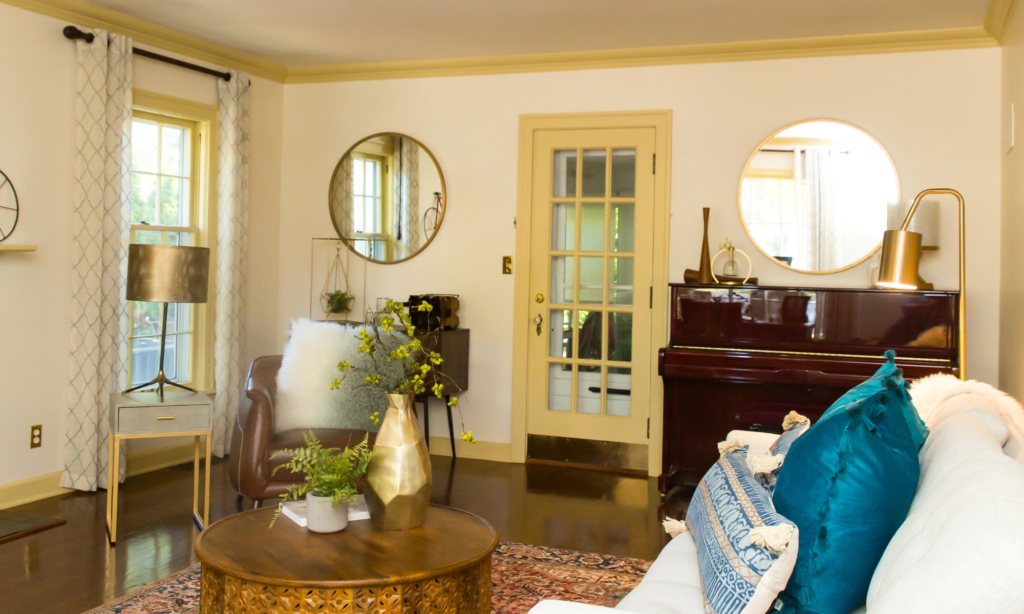 a living room filled with furniture and a piano.