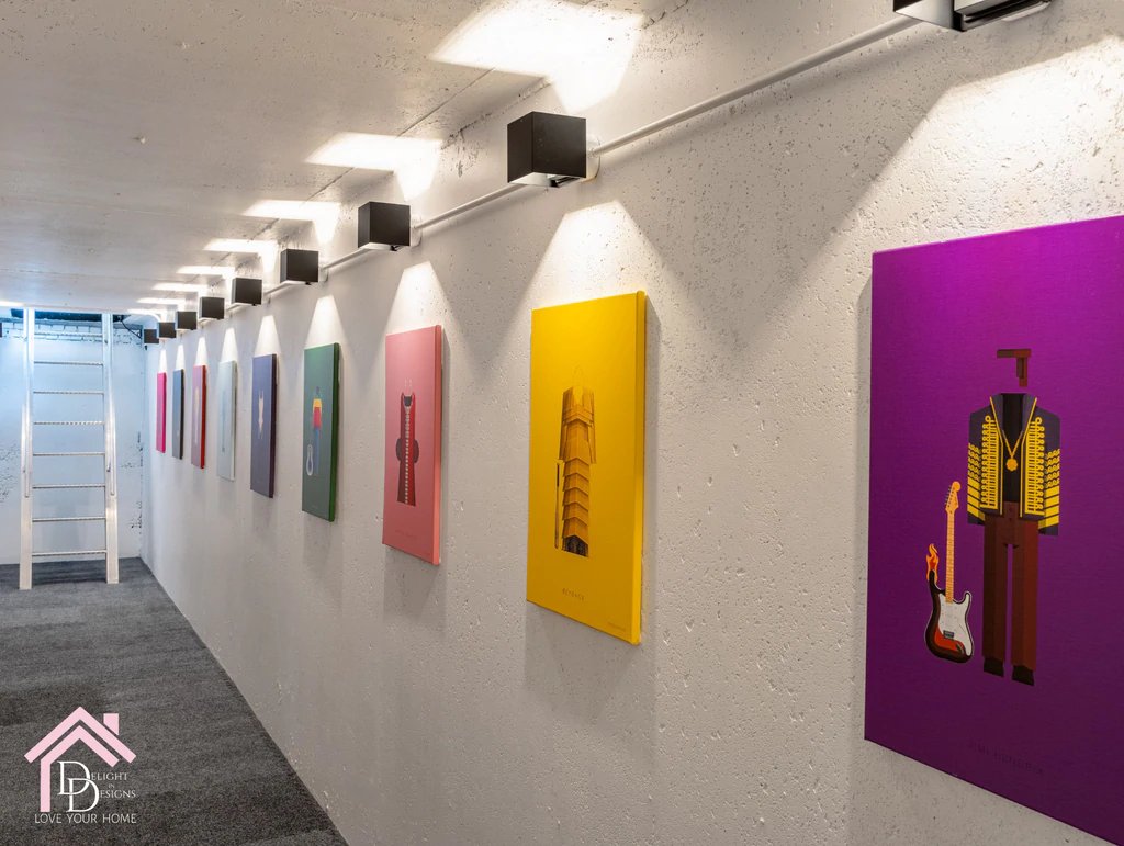 a row of colorful paintings on a white wall.
