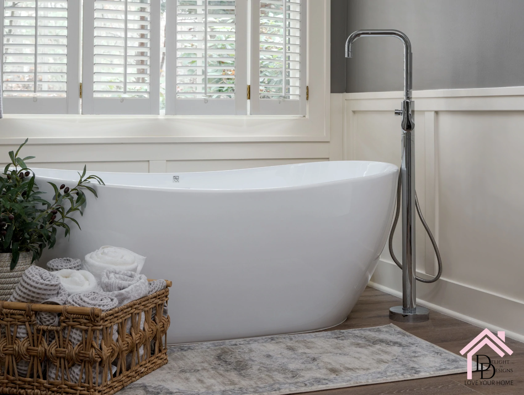 a white bath tub sitting in a bathroom next to a window.