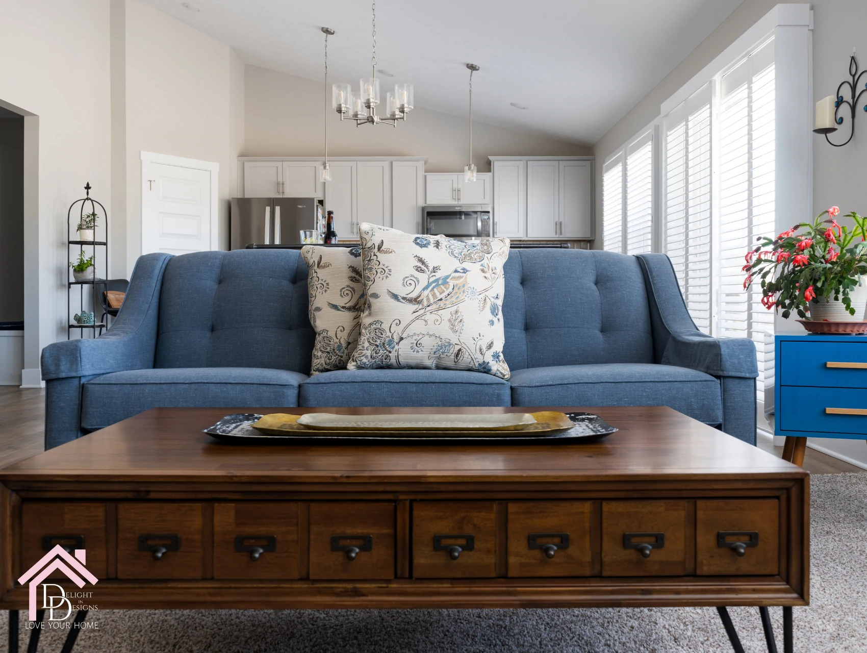 a living room with a blue couch and a coffee table.