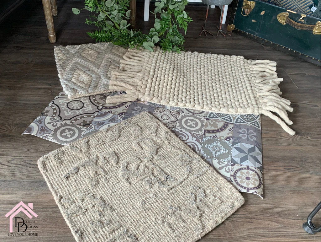 a pile of rugs sitting on top of a wooden floor.