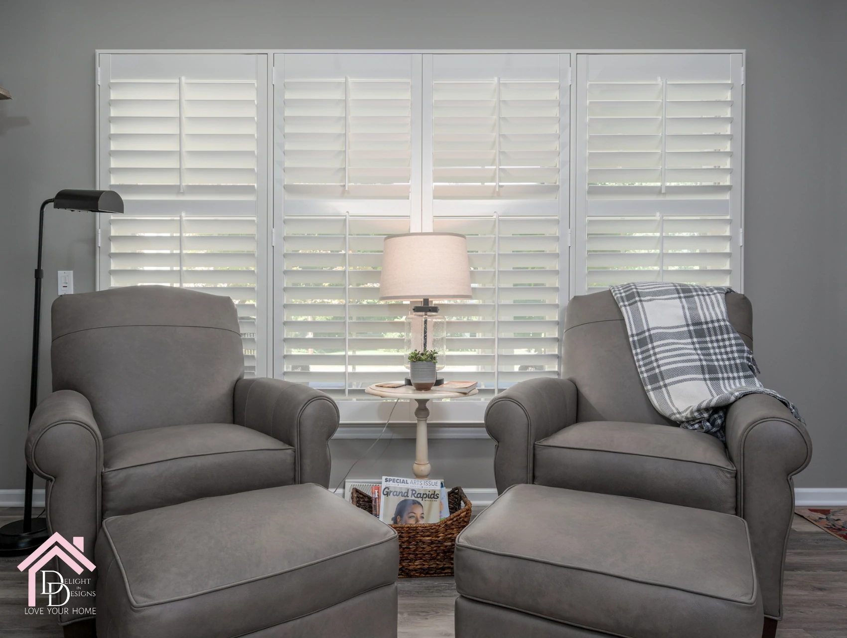 a living room with two chairs and a lamp.