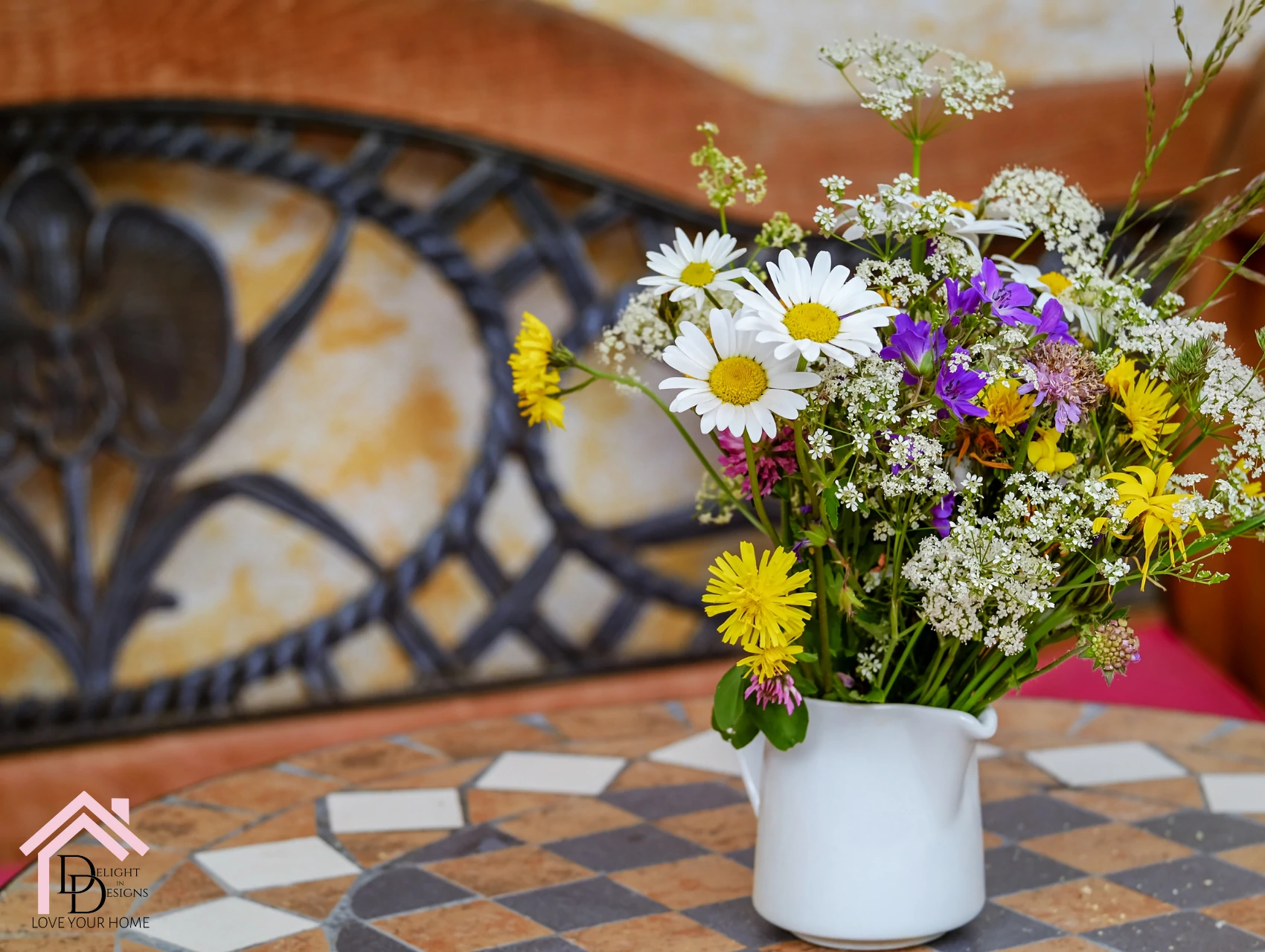 a vase filled with flowers sitting on top of a table.