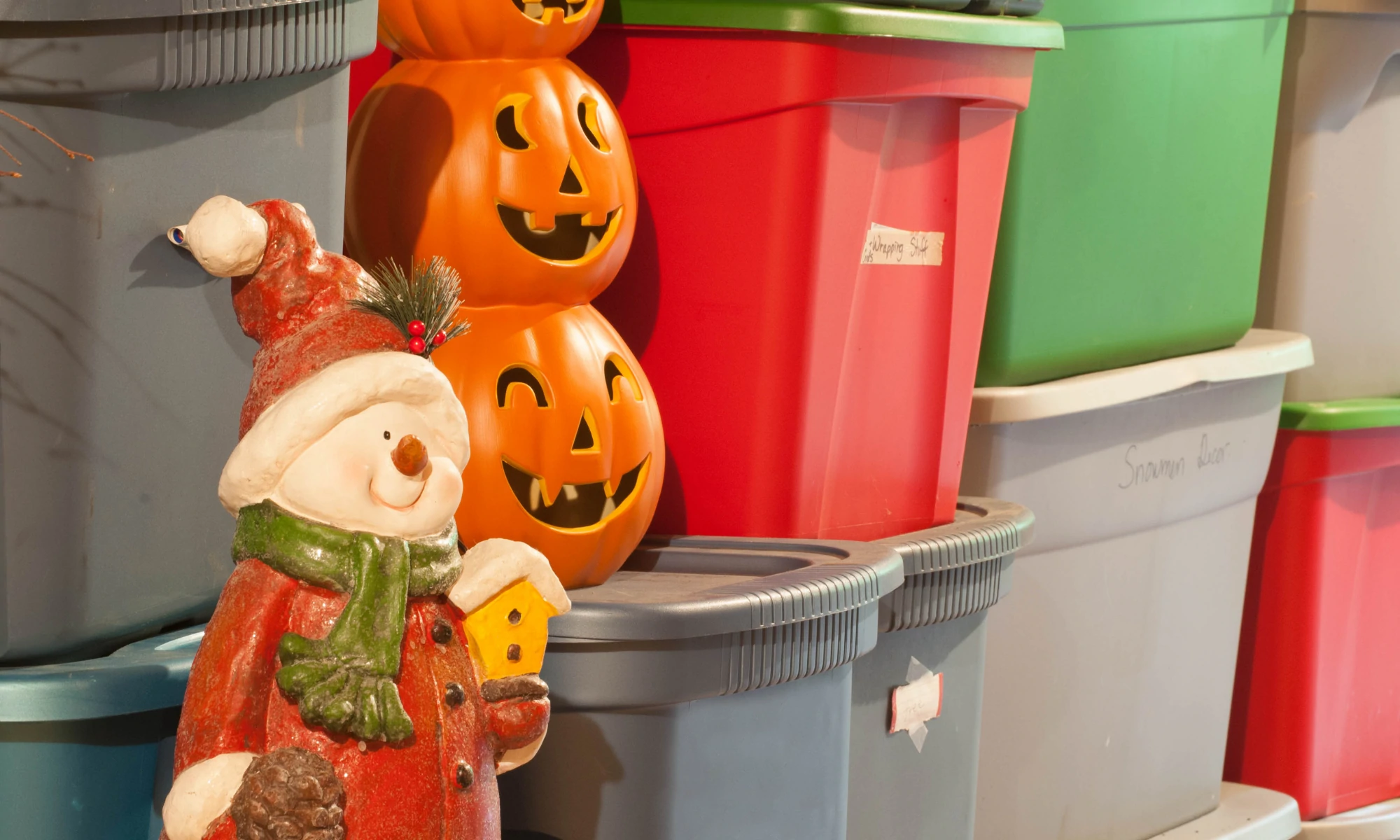 a statue of a santa clause holding a pumpkin.