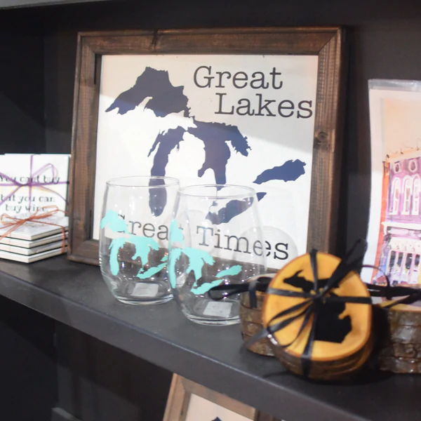 a shelf with a picture and some glasses on it.