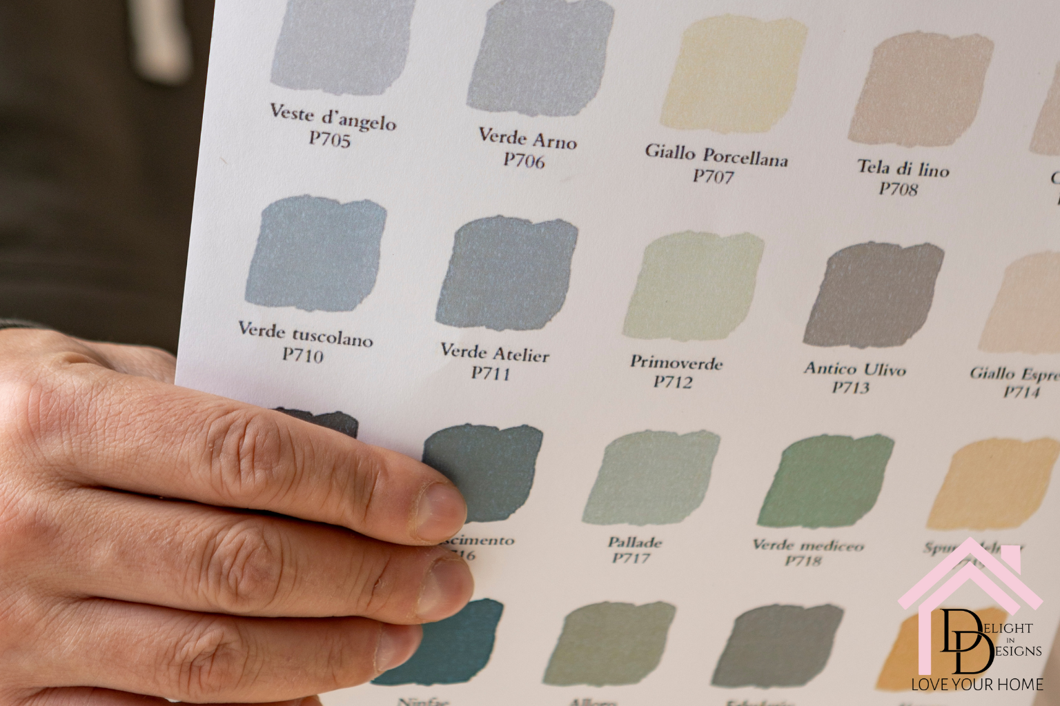 Someone holding a paint swatch remodeling blunders