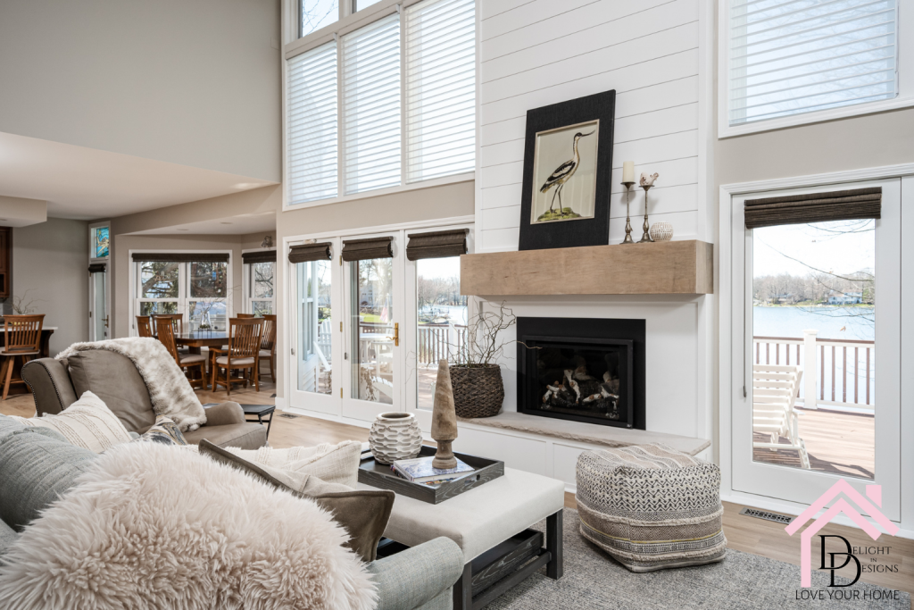 Living room with large windows and grand fireplace interior design