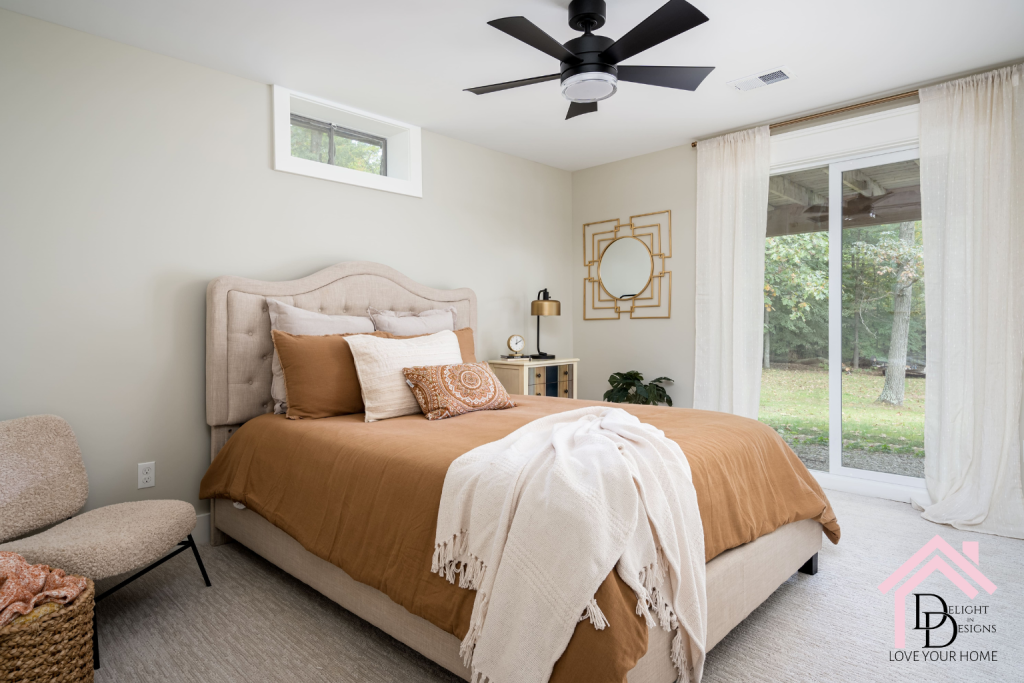 Basement Guest room with a burnt orange comforter, cream upholstered headboard and many accent pillows New Year Resolutions